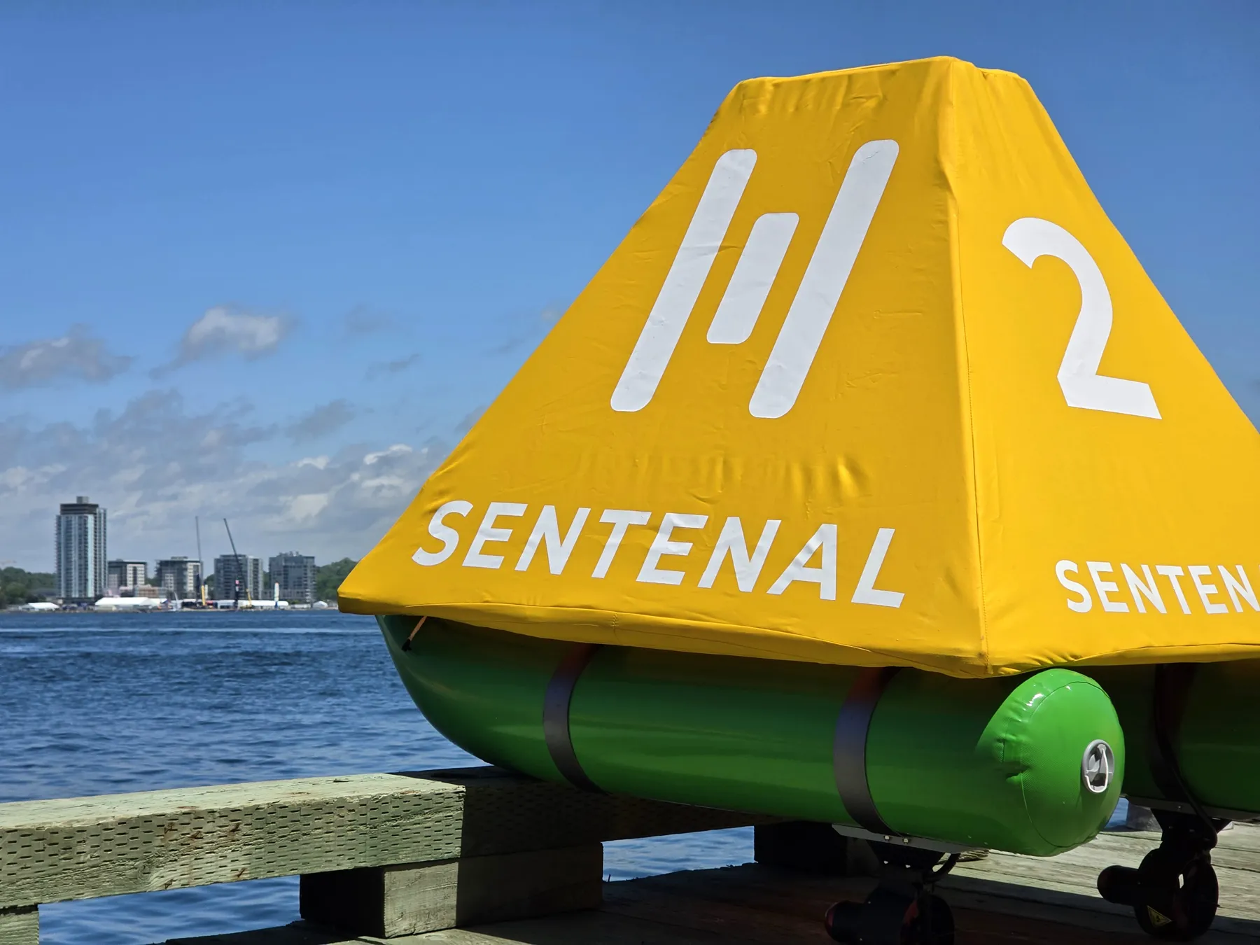 A Sentenal mark top with logo and number against open water